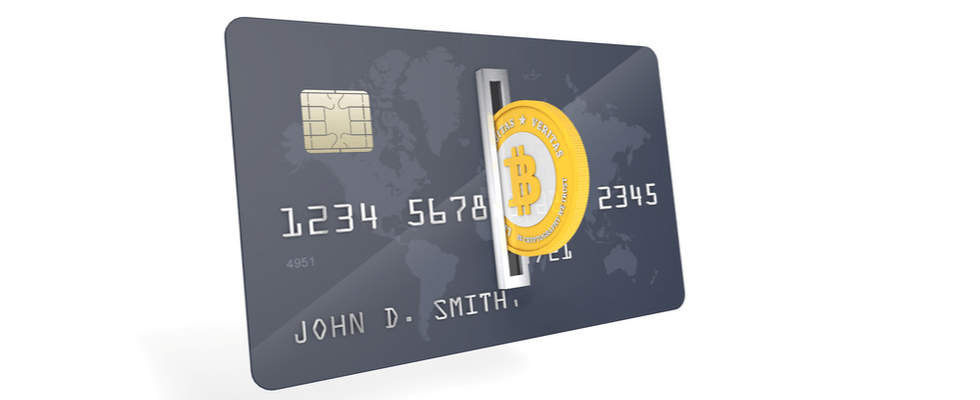 A credit card overlays a world map, partially covered by a Coinmama Bitcoin, symbolizing cryptocurrency integration.