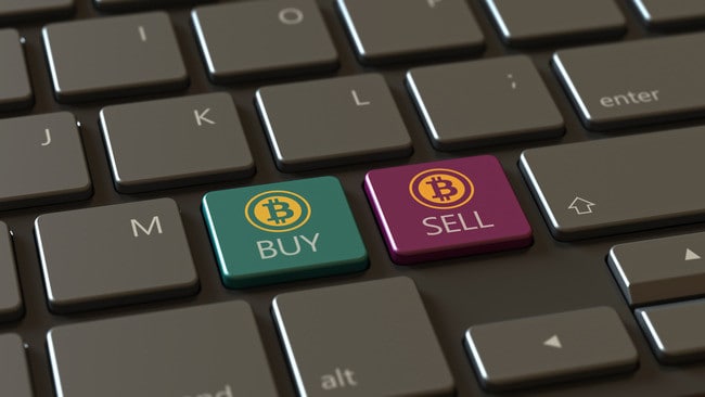 The keyboard features standout "BUY" and "SELL" Bitcoin keys, highlighting crypto transactions via Coinmama.