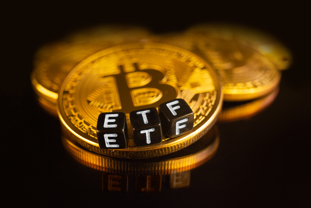 Close-up of a Bitcoin coin against a black background with “ETF” blocks; consider Coinmama to buy Bitcoin.