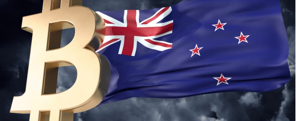 A large gold Bitcoin symbol stands out against a wavy New Zealand flag, attracting BTC enthusiasts.