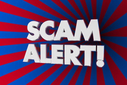 Bold white text stating "SCAM ALERT!" is displayed in the center of the image. A dynamic background with radiating red and blue lines creates a sense of urgency, capturing attention for anyone looking to buy Bitcoin or invest in crypto through platforms like Coinmama.